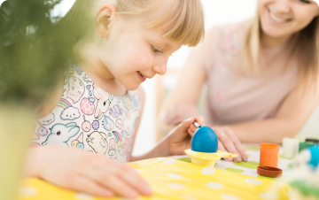 happy-mother-painting-egg-with-daughter