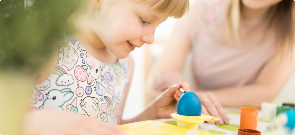 happy-mother-painting-egg-with-daughter